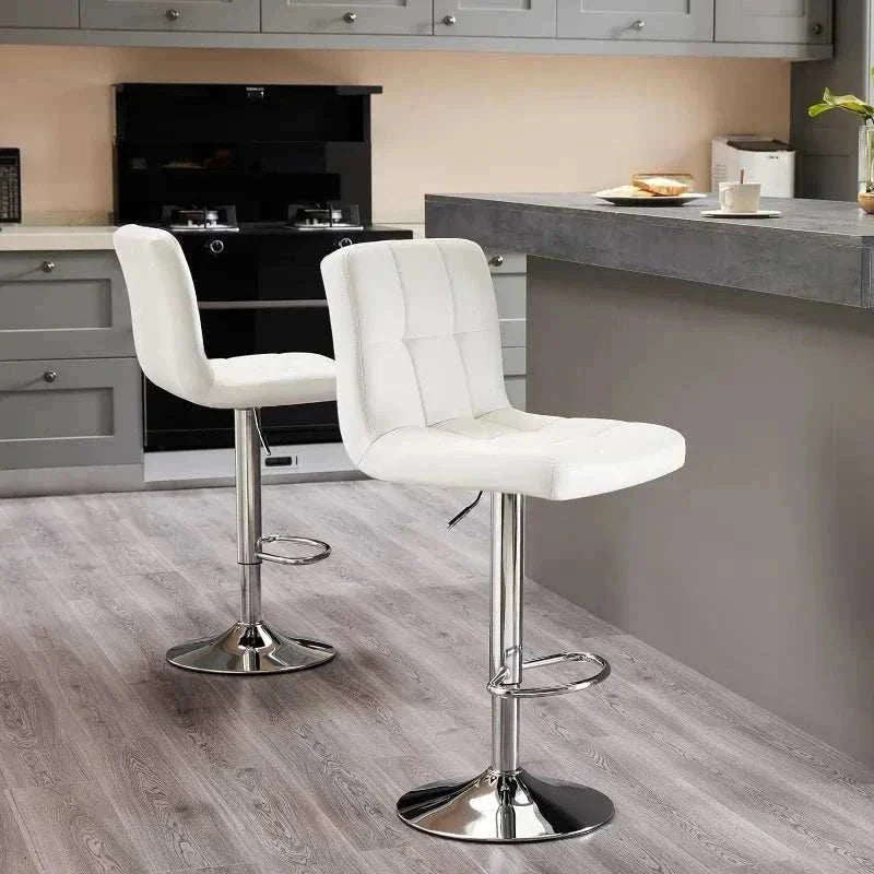 Adjustable swivel white armless bar stools with hydraulic lift and chrome base in modern kitchen setting