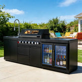 Stainless steel outdoor kitchen on wheels featuring grill, sink, and fridge, perfect for backyard cooking.