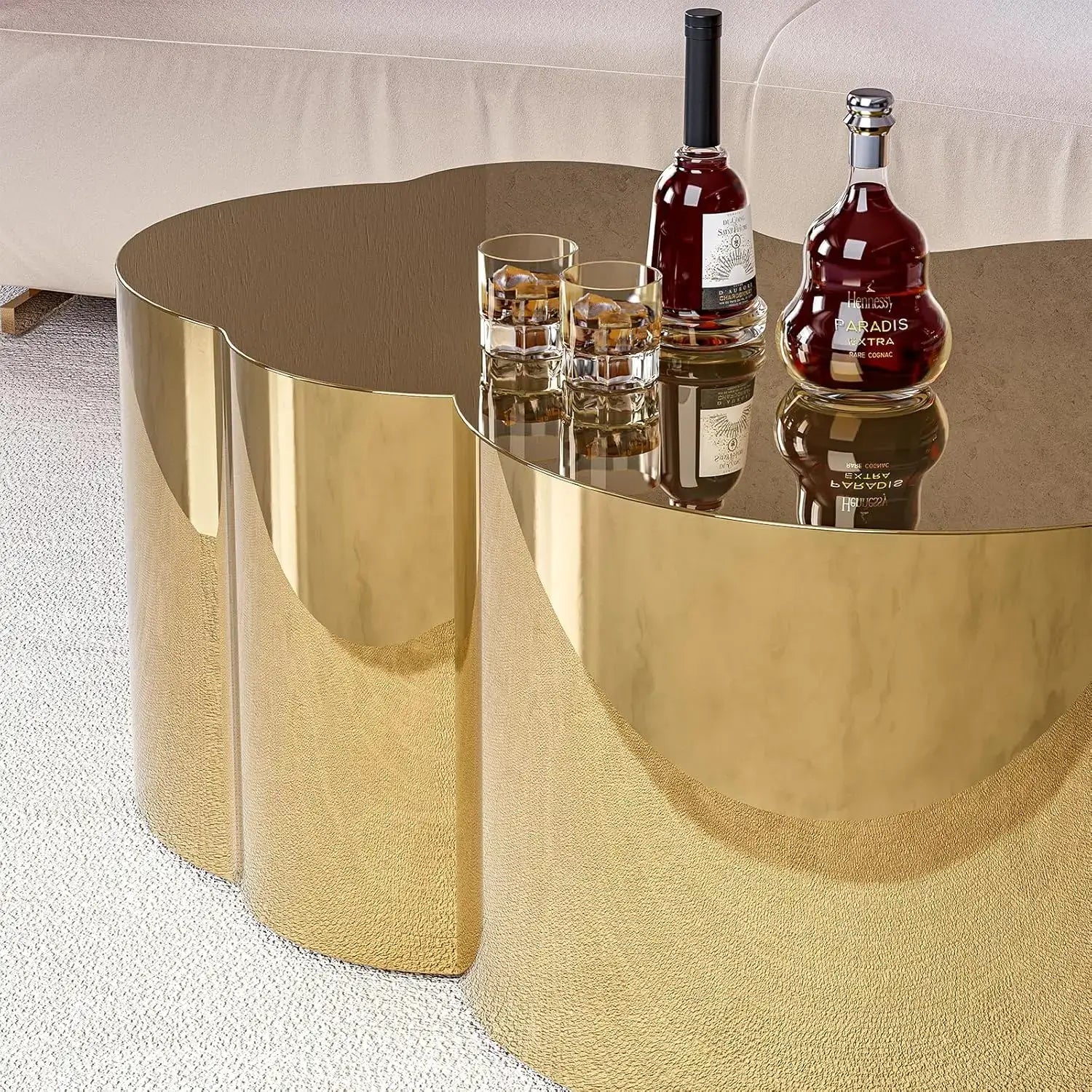 Modern gold stainless steel coffee table featuring cloud design with drinks on top.