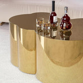 Modern gold stainless steel coffee table featuring cloud design with drinks on top.