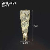Large gold crystal wall lamp with cascading crystals and dimensions 76cm height and 27cm width illuminating with E14 bulbs