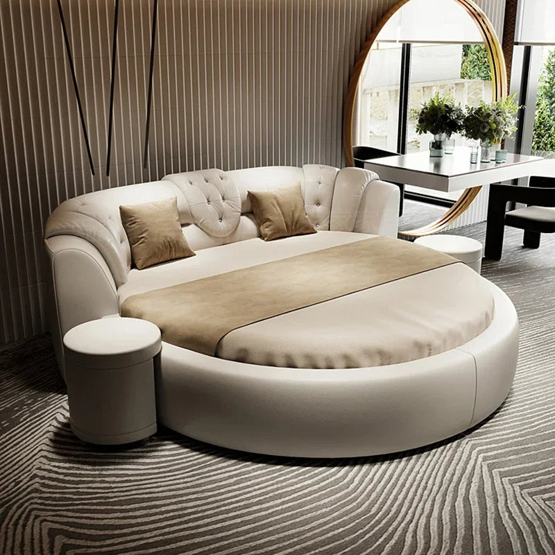 Modern circular sofa in a stylish living room with a mirror and table in the background.
