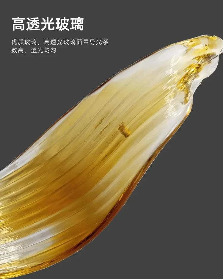 Clear glass object with gold interior on a dark background