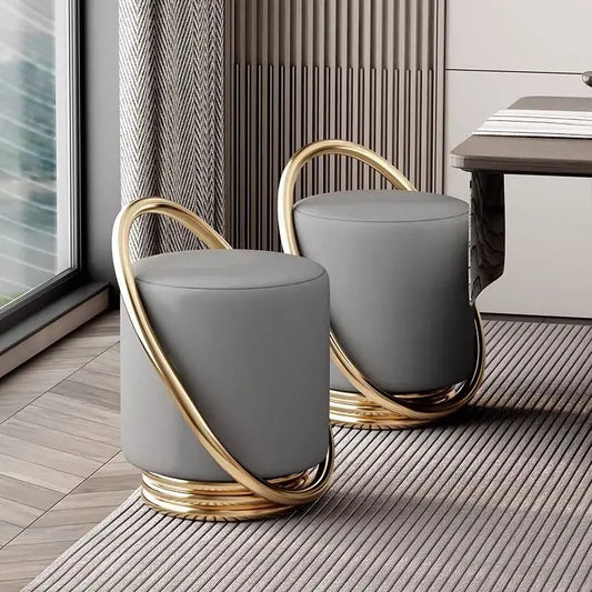 Nordic modern dressing table set with stylish gray stools featuring gold accents and round design.