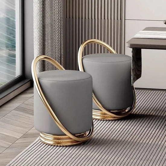Nordic modern dressing table set with stylish gray stools featuring gold accents and round design.