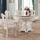 4 person gold dining table in a modern living room setting with elegant chairs and stylish decor.