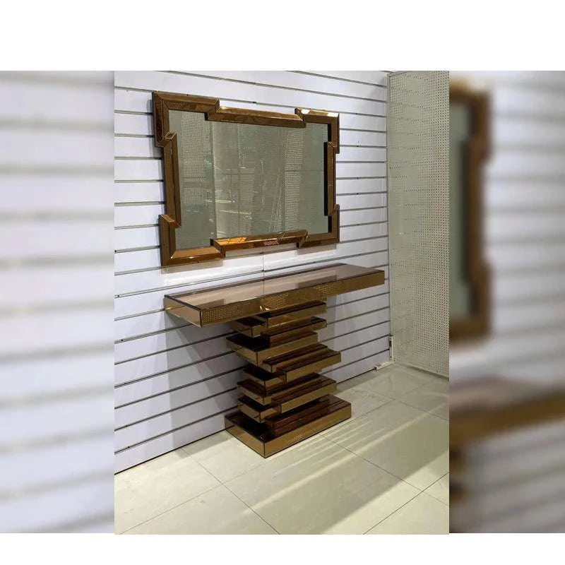 Wooden console table with mirror against a white paneled wall.