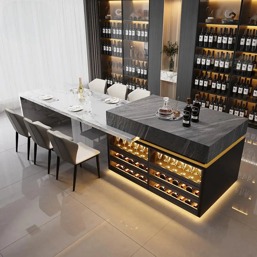 Modern dining room with a long table and wine bottles displayed on shelves.
