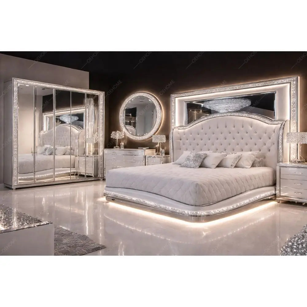 A luxury bedroom set featuring a tufted silver bed with a large mirrored headboard and LED under-bed lighting, a matching mirrored wardrobe, and silver nightstands with lamps.