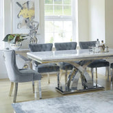 Dining room with a modern table and chairs in a well-lit room.