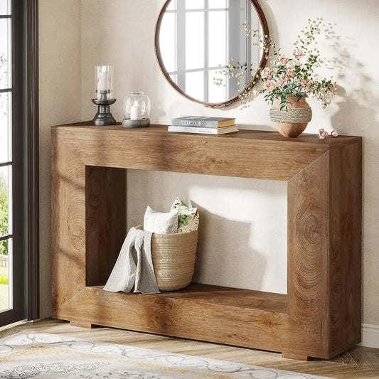 Wooden console table with decorative items in a room with a mirror and window.