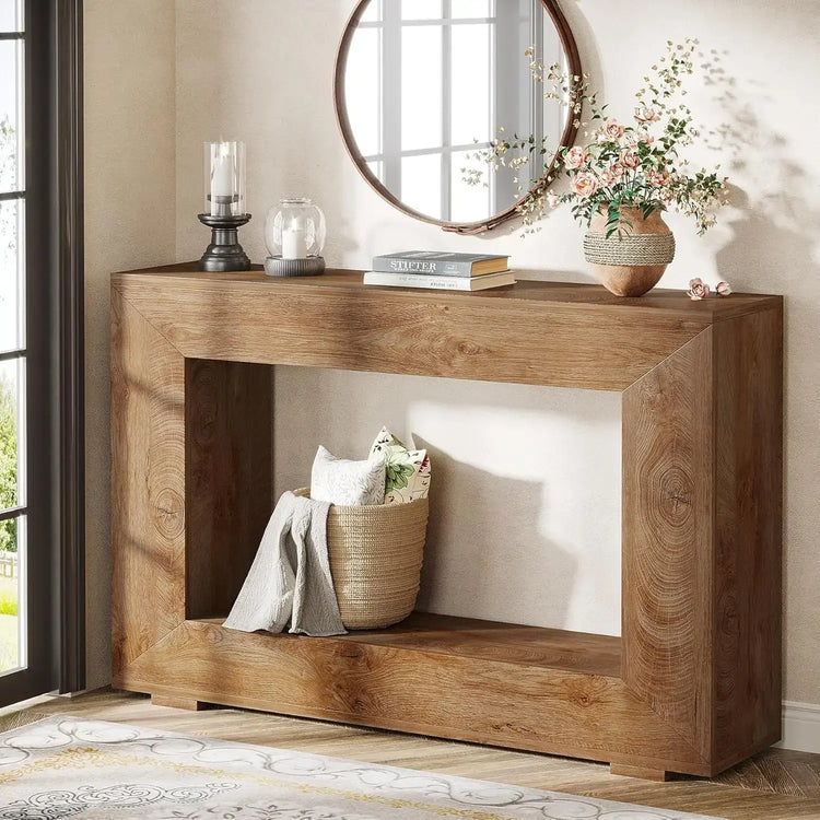 Wooden console table with decorative items in a room with a mirror and window.