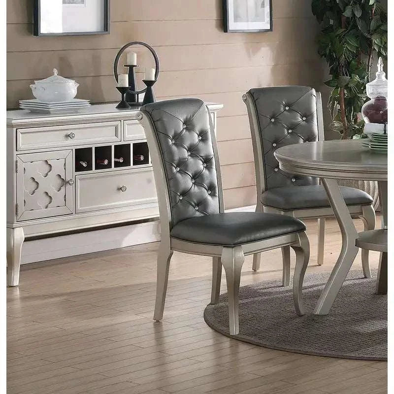 Dining room with gray upholstered chairs and a white sideboard.