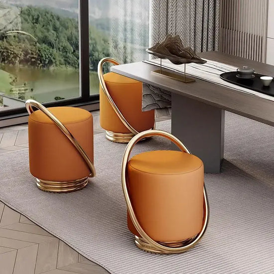 Nordic modern dressing table set with stylish orange stools and elegant gold accents in contemporary interior design.