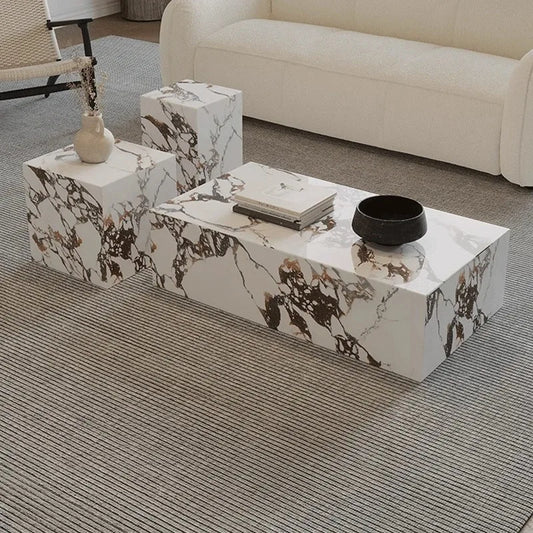 Marble-patterned coffee table with decorative items in a living room setting