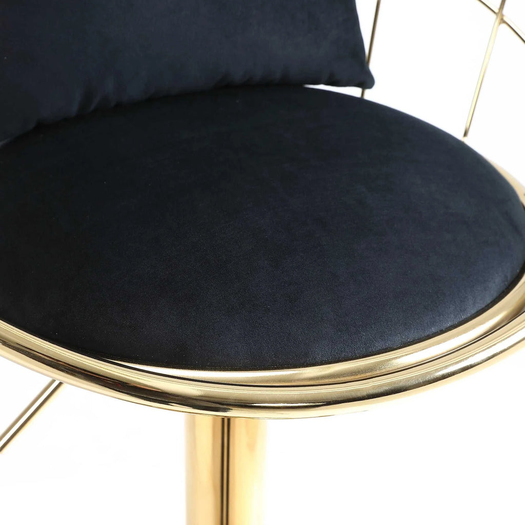 Black cushioned chair with gold frame on a white background