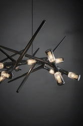 Modern chandelier with multiple light bulbs on a dark background