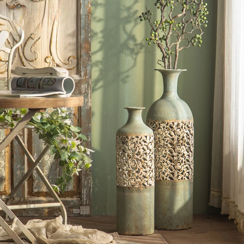 Vintage metal floor vase decor displayed in a stylish interior with floral accents and elegant design.