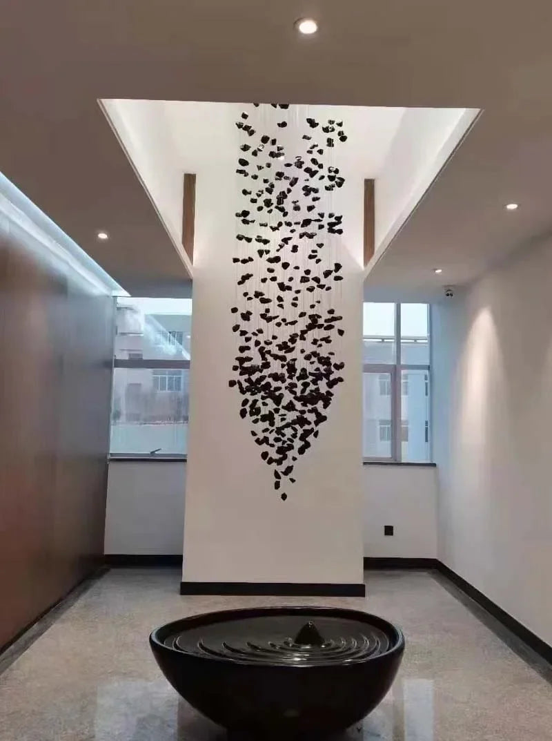 Modern interior with a decorative wall art installation and a black bowl on the floor.