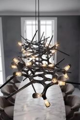 Modern chandelier with black and gold design in a room setting