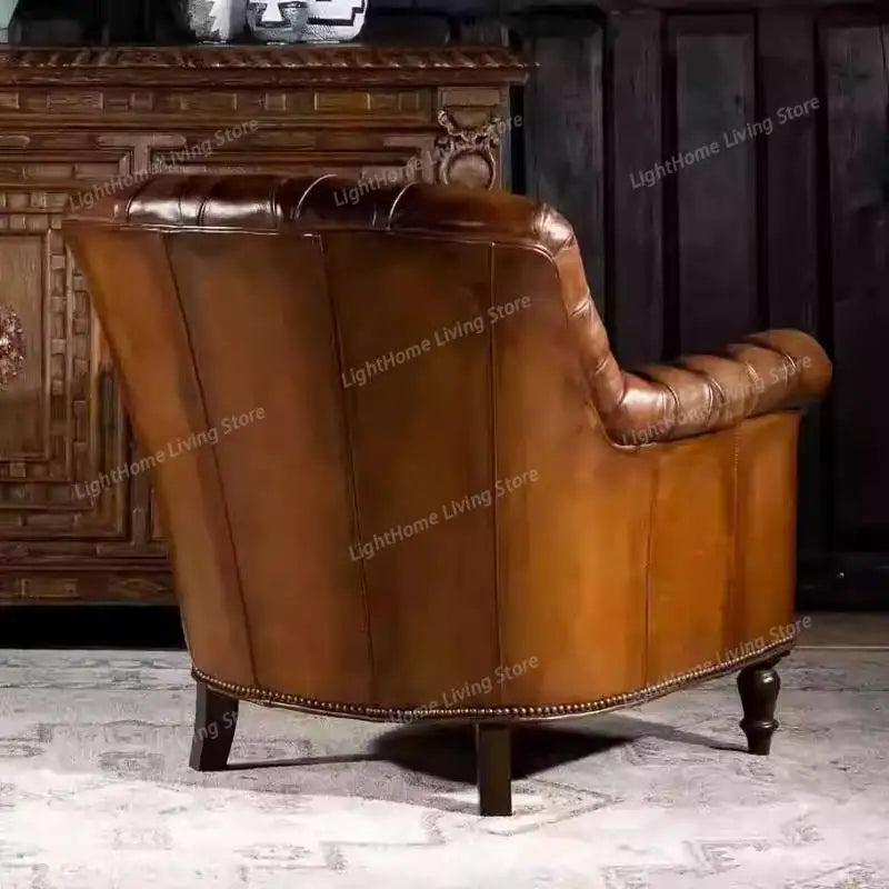 Brown leather armchair in a room with wooden furniture.