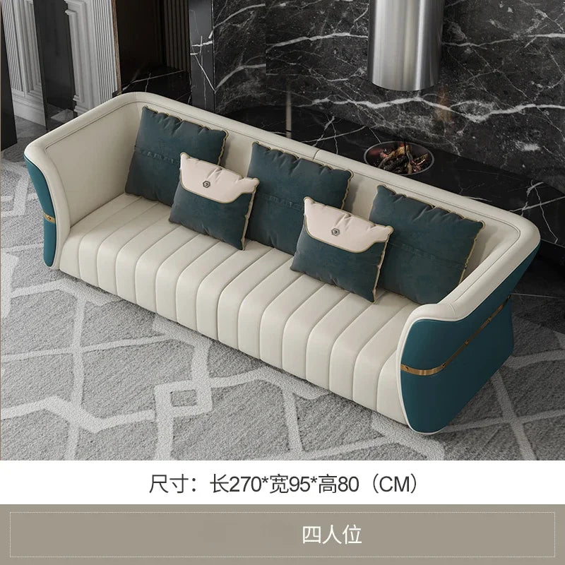 White and blue sofa with cushions in a room with a fireplace.