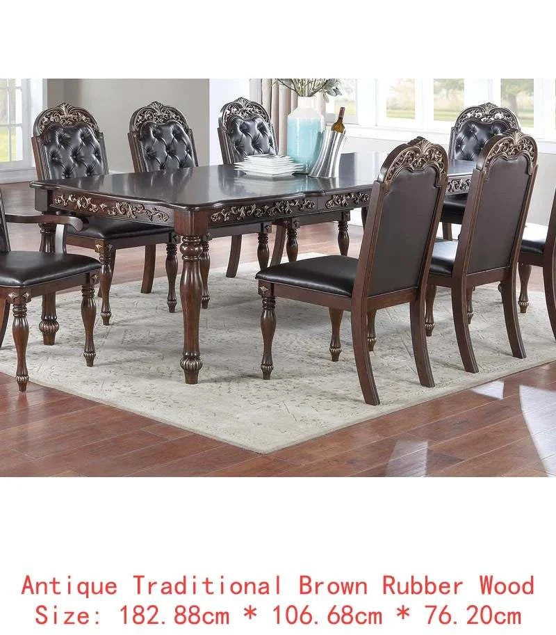 Dining table set with chairs in a room with large windows.
