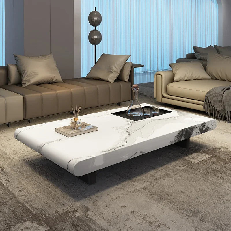 Modern living room with a marble coffee table and beige sofas.