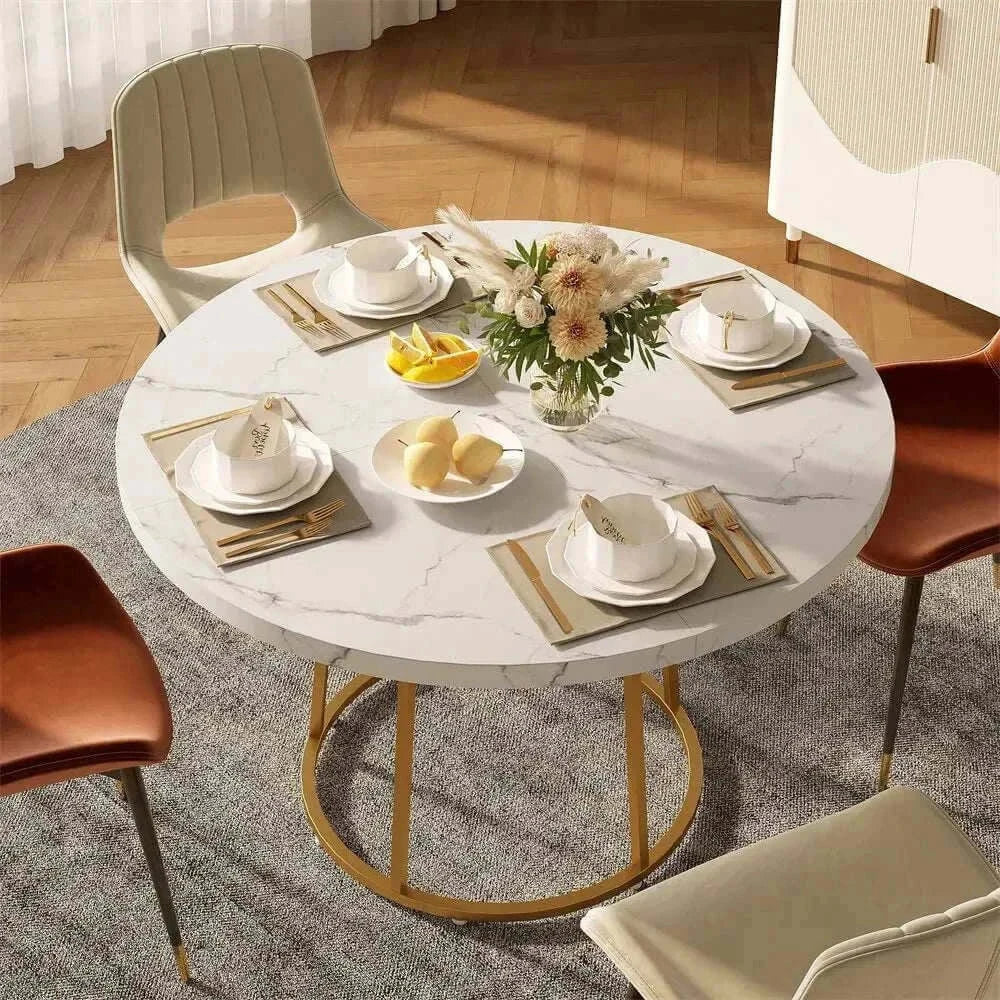Round dining table for 4 set with dishes and flowers in stylish dining area.