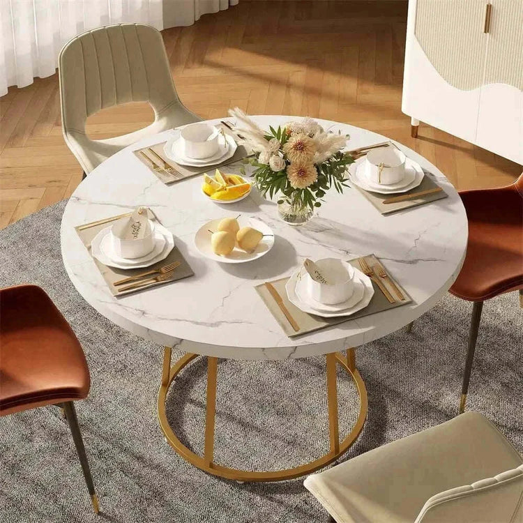 Round dining table for 4 set with dishes and flowers in stylish dining area.