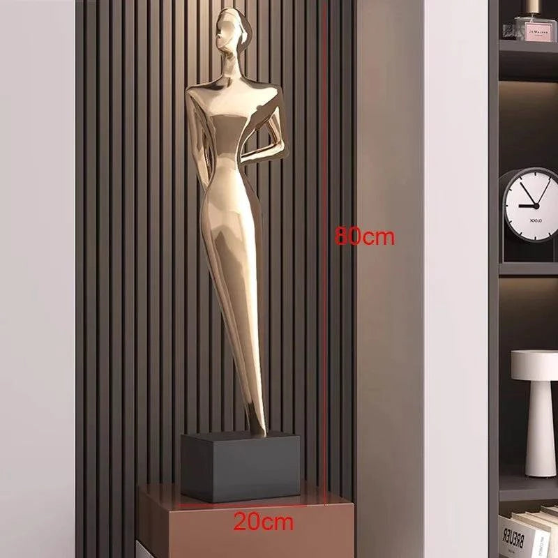 Gold statue on a pedestal with dimensions indicated, against a neutral background.