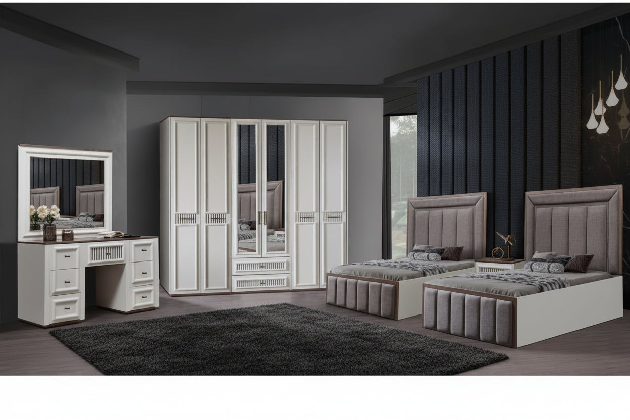 A modern bedroom furniture set including a white double bed with tufted gray upholstered headboard and footboard, a matching three-door wardrobe with mirrored doors, a white vanity desk with drawers, and a brown area rug on a gray wood floor.