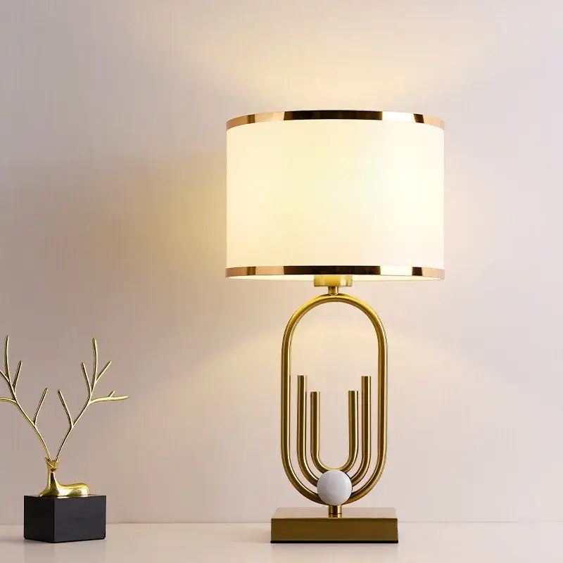 Nordic luxury bedside lamp with gold accents and warm white light for a romantic glow.