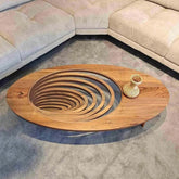 Wooden coffee table with spiral design in a living room setting