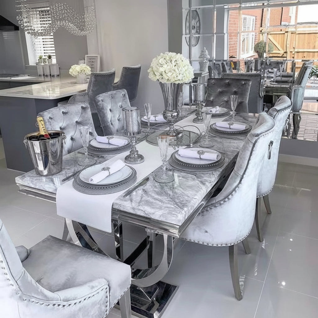 Luxury marble dining table set with designer silver frame and plush chairs, elegantly arranged for dining.