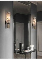 Modern wall sconces with decorative glass shades in a stylish interior setting.
