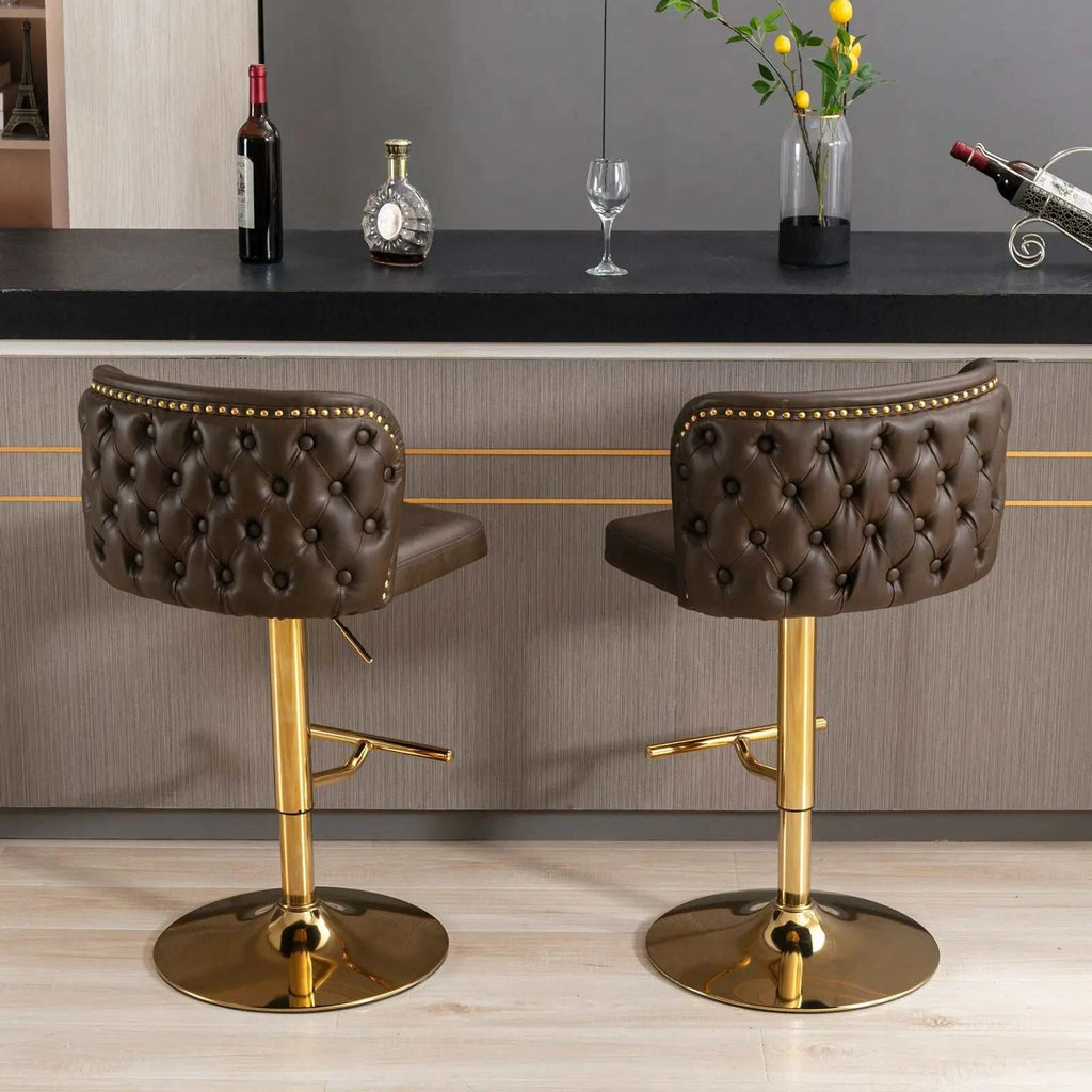 Two brown bar stools with gold legs in front of a bar counter.