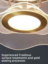Close-up of a round modern led ceiling chandelier showcasing its gold plating and intricate surface treatments.