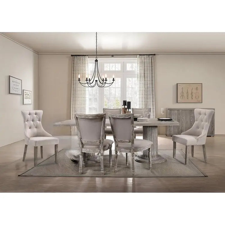 Dining room with a round table and chairs in a well-lit room.