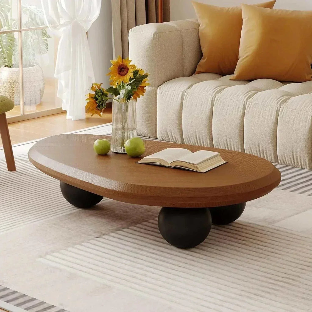 Round wooden coffee table with wheels in a living room setting