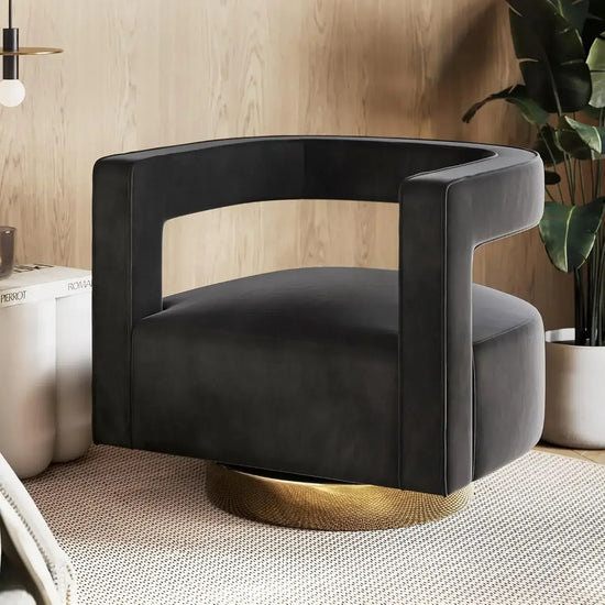 Black armchair with gold base in a modern interior setting