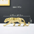 Gold panther figurine with dimensions on a dark background