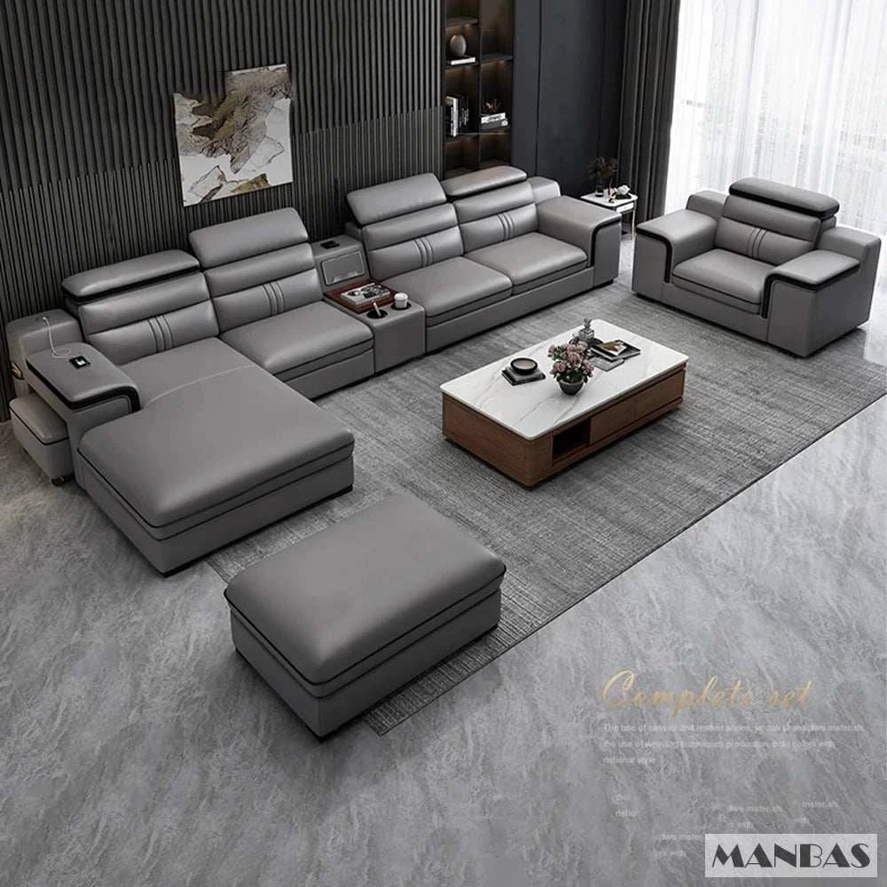 Gray sectional sofa set with a coffee table in a modern living room setting, featuring the brand 'Manbas'.