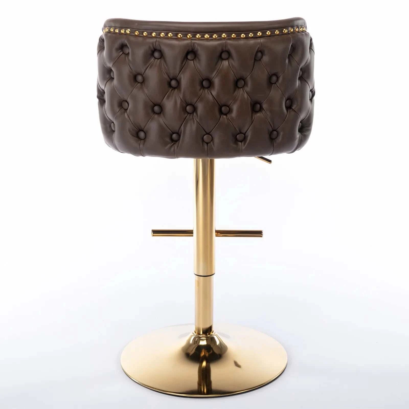 Brown tufted stool with gold base on a white background