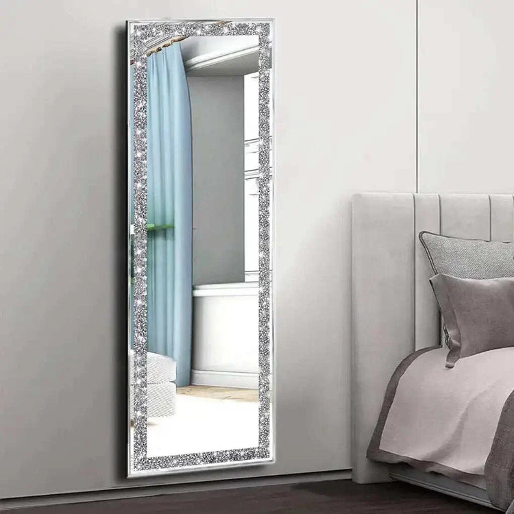 Large silver frameless mirror with crystal rhinestone and diamond border in bedroom setting