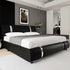 Modern faux leather upholstered platform bed with curved headboard and metal accents in a contemporary bedroom setting