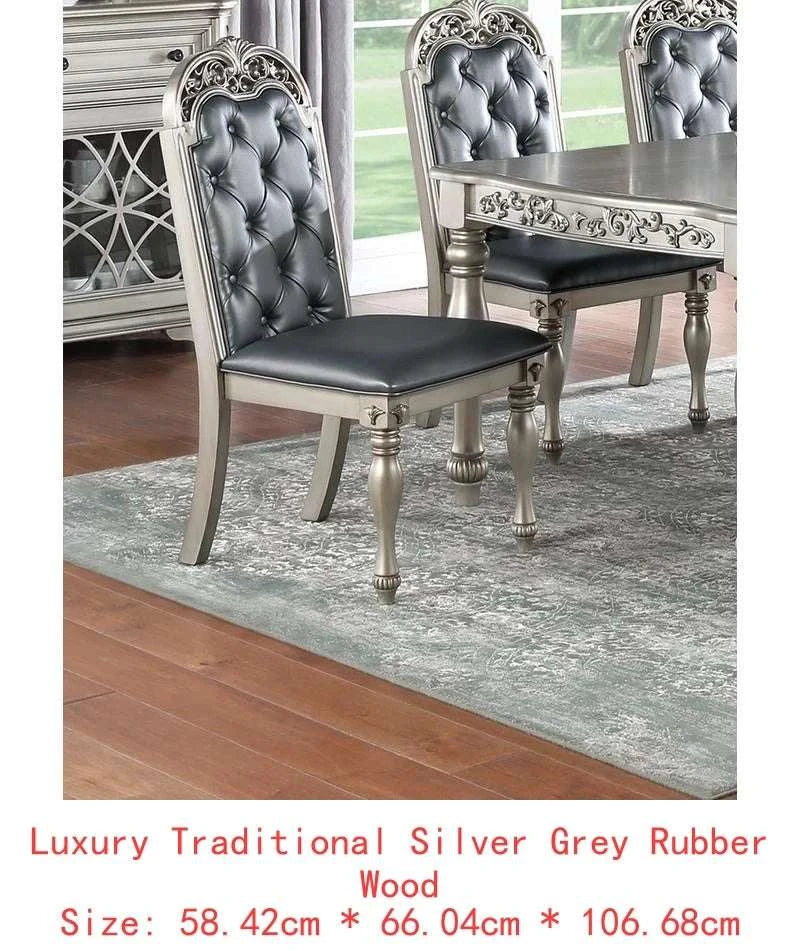 Dining room set with silver and gray chairs on a wooden floor.