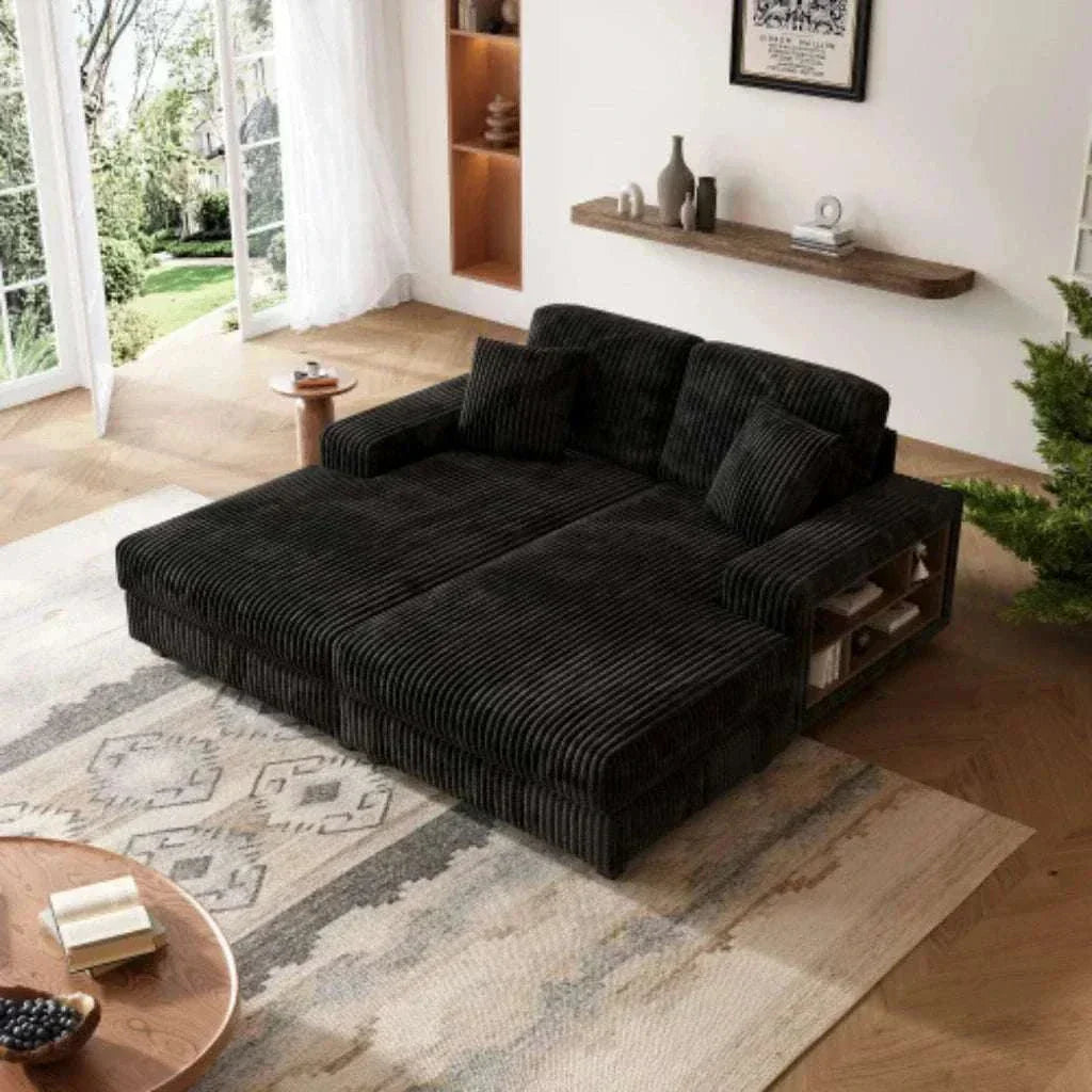 Black sectional sofa in a modern living room with a rug and window view.