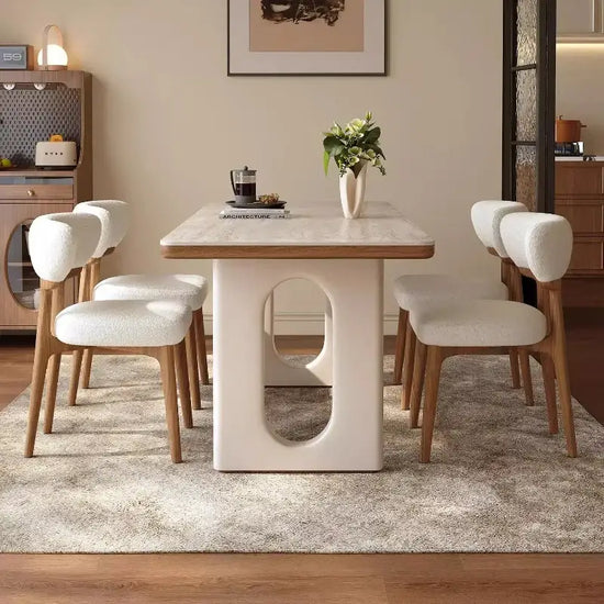 6 person white dining table with modern Nordic design and comfortable chairs in a stylish living room setting.