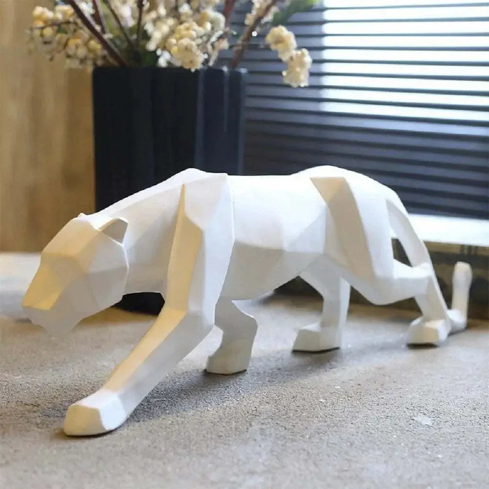 White geometric tiger sculpture on a surface with a blurred background